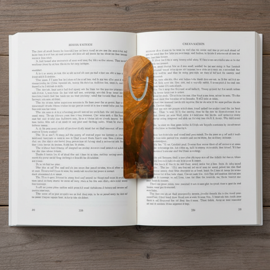 Whispers of Fall abstract art aluminum bookmark resting inside an open book — is also part of the Autumn Cozy Duo with matching pillow cover, seasonal fall gift set.