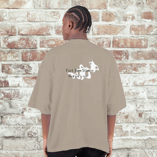 Back of oatmeal Fart Boy Slim oversized t-shirt with “the funk is real” design and puff graphic, worn in front of a white brick wall.