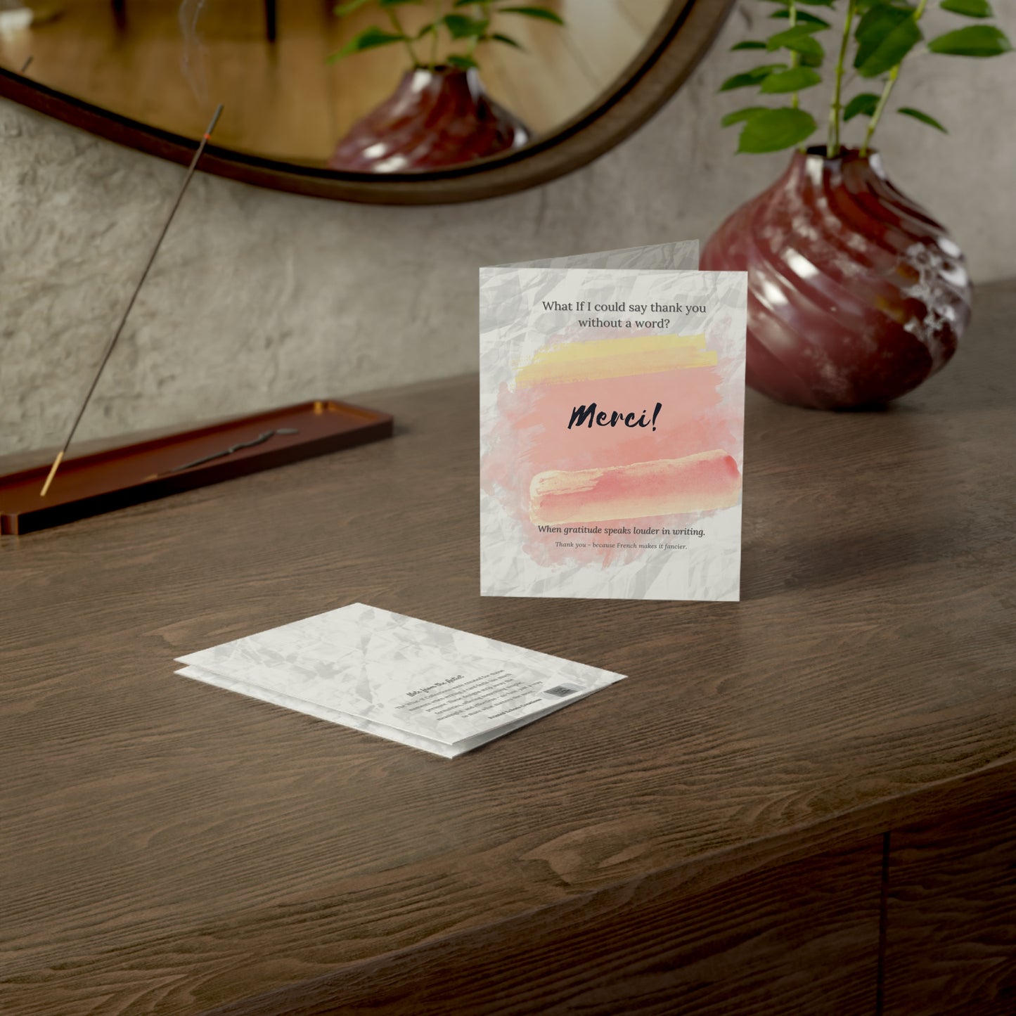 Merci French thank you card displayed on a wooden desk with envelope—ideal for thoughtful gestures and teacher appreciation gifts.