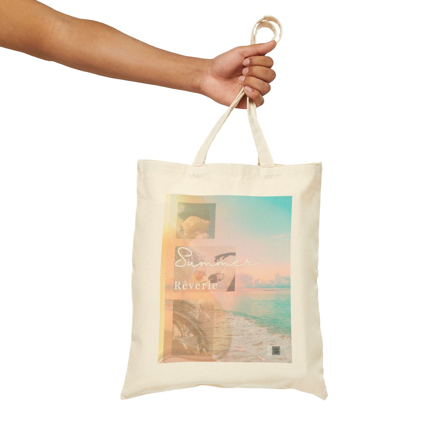 Hand holding the Summer Rêverie tote bag, showcasing the front design with poetic beach imagery and soft pastel tones against a clean background.