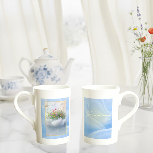 Front and back view of The Blue Hour Mug showing floral cloud artwork with lace-bird illustration and “Know your own happiness” quote, styled with teapot and curtain-light backdrop.