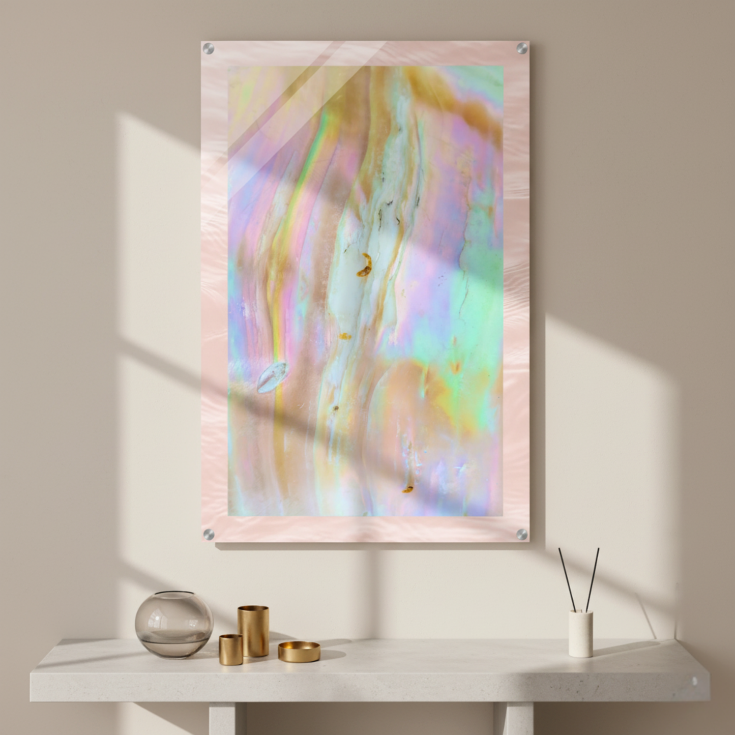 The Veil iridescent acrylic wall art displayed above a modern console with brass accents and a glass orb, styled in a minimalist living space.