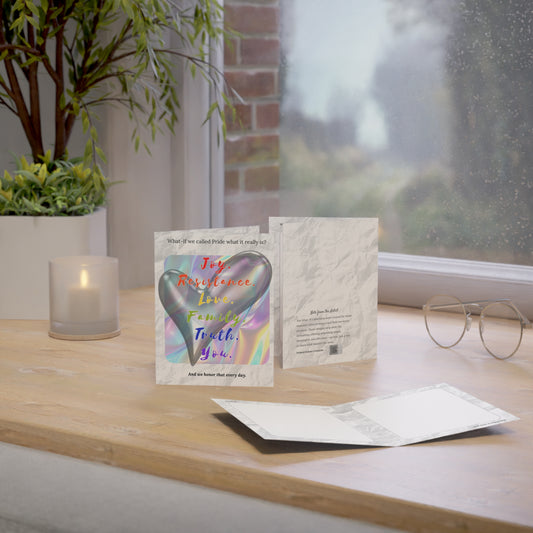 Pride greeting card displayed on a desk with warm light and everyday objects, evoking a casual, heartfelt moment.