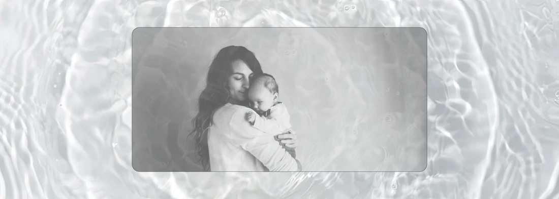 Black and white portrait of a mother gently holding her baby in a quiet embrace — visual representation of presence, tenderness, and the emotional landscape explored in a motherhood reflection blog article.