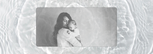 Black and white portrait of a mother gently holding her baby in a quiet embrace — visual representation of presence, tenderness, and the emotional landscape explored in a motherhood reflection blog article.