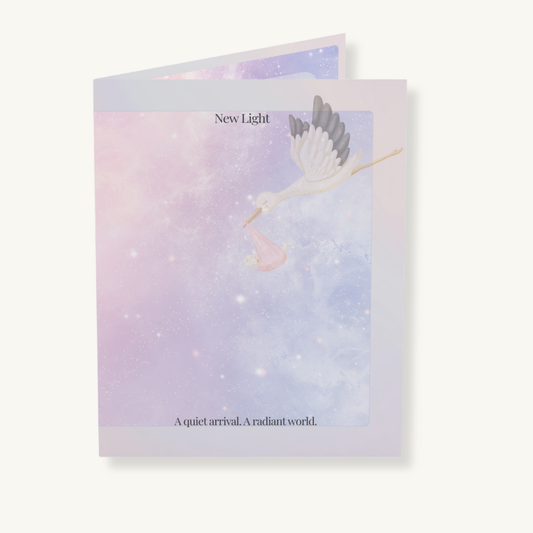 New Light baby arrival card layered on soft beige background, showing celestial heron illustration and poetic front text.