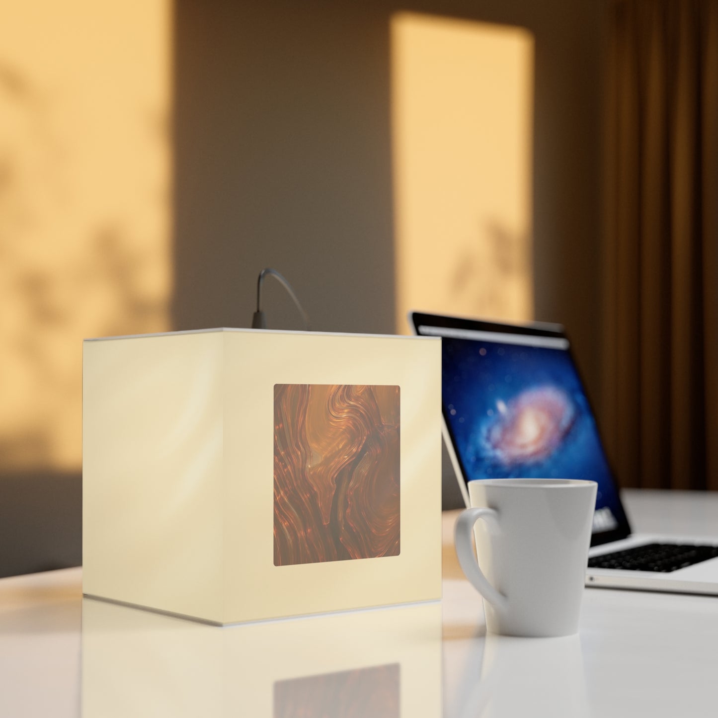 Whispers of Fall light cube lamp glowing on a wooden table beside a ceramic mug, autumn-inspired ambient lighting for cozy interiors.