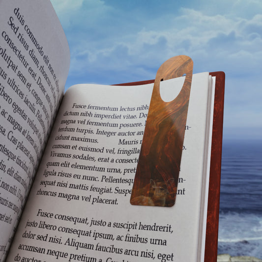 Surrealist Whispers of Fall bookmark resting inside an open book, elegant aluminum page holder for cozy autumn reading