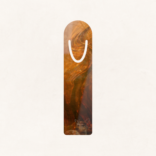 Minimal flat lay of the Whispers in the Leaves surrealist aluminum bookmark featuring full Whispers of Fall capsule artwork