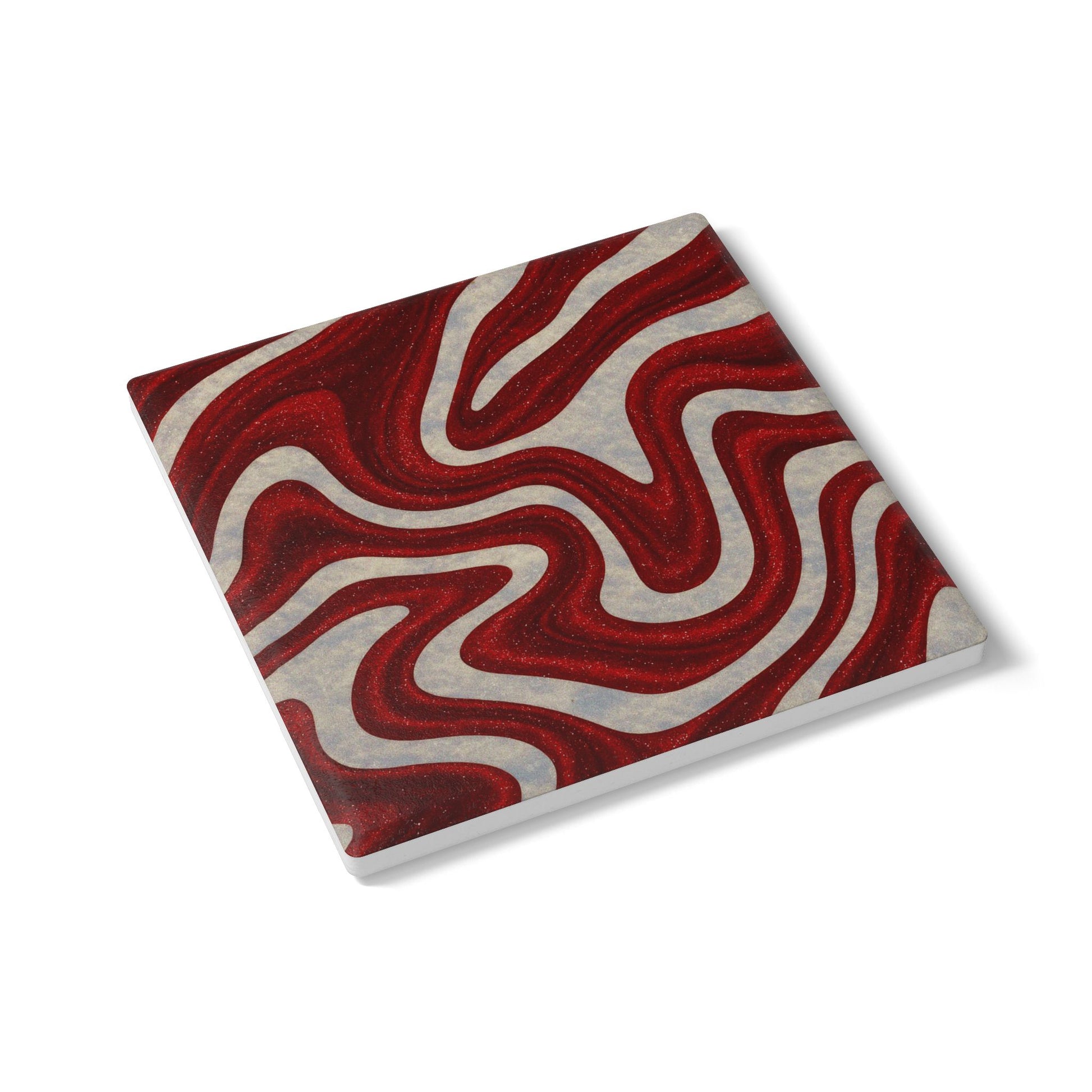 Angled view of Candy Swirl coaster showing red and white swirl design with modern square shape, holiday entertaining accessory by Printed Echoes Creations.