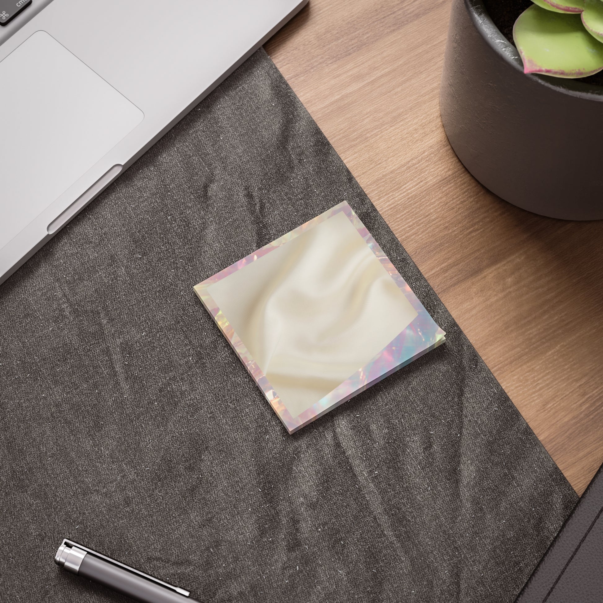Daily Whisper sticky note with silk texture and iridescent trim styled on a soft charcoal desk mat beside a laptop and succulent – modern slow workspace setup
