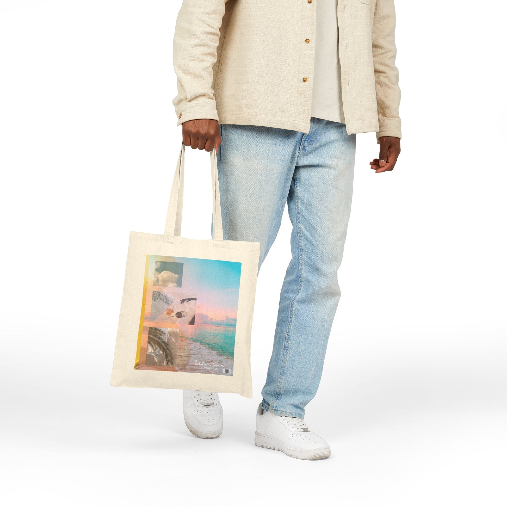 Model holding the Golden Hour in Provence side of the Summer Rêverie tote bag, showcasing the dreamy beach collage and soft pastel design.