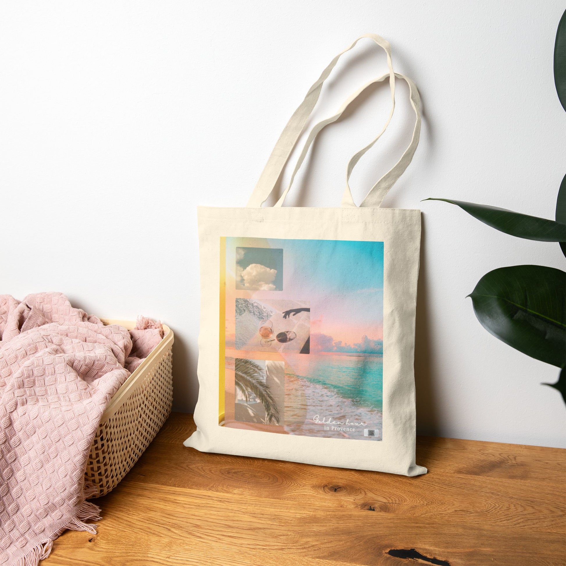 Golden Hour in Provence side of the Summer reverie tote bag styled on a wooden table with a soft blanket and house plant, evoking cozy summer morning vibes