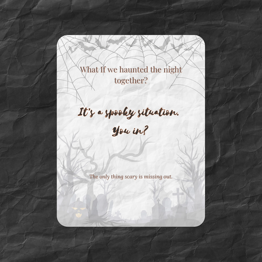 Flat lay of the What If Halloween Invite card featuring the message “What if we haunted the night together?” with spooky trees, bats, and a crinkled dark paper background — a moody, casual art card for seasonal gatherings.
