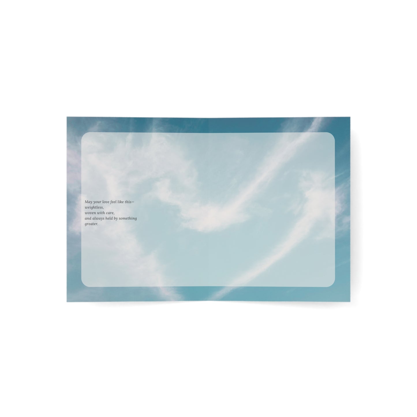 Open view of the Held in Lightness wedding card showing a poetic message against a soft blue sky background. A minimalist, ethereal design reflecting gentle devotion.
