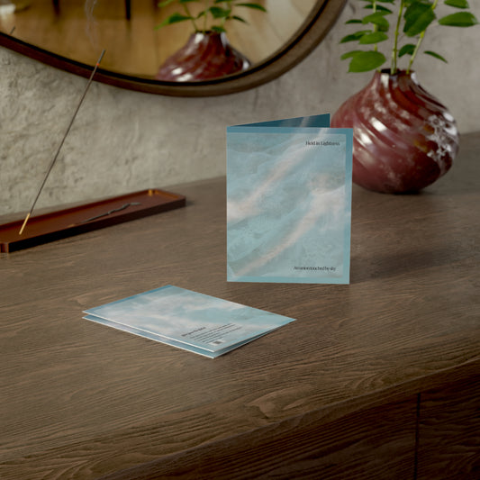 Lifestyle shot of the Held in Lightness wedding art card displayed on a wooden desk with soft lighting, incense, and a sculptural vase. Elegant and poetic greeting card scene.
