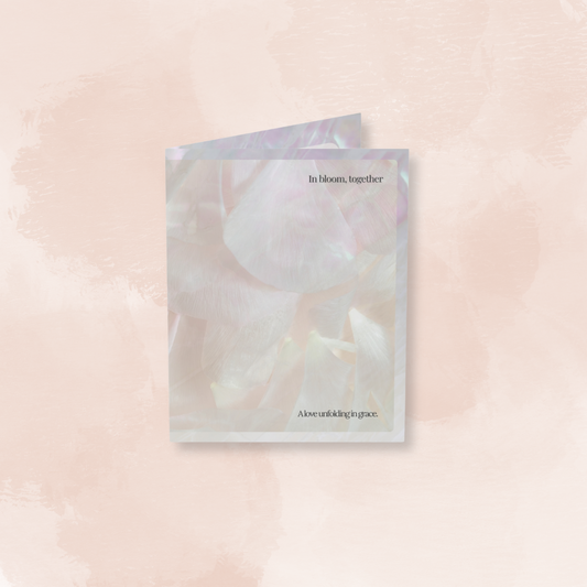 Front cover of the In Bloom, Together art card, featuring soft layered petals and a poetic message—“A love unfolding in grace.”
