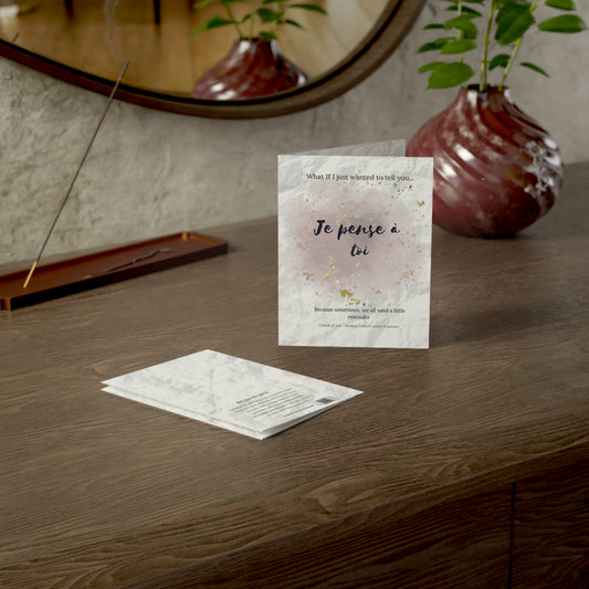 Je pense à toi card styled on a wooden desk beside a mirror and a ceramic vase, part of the What-If Collection by Printed Echoes Creations.