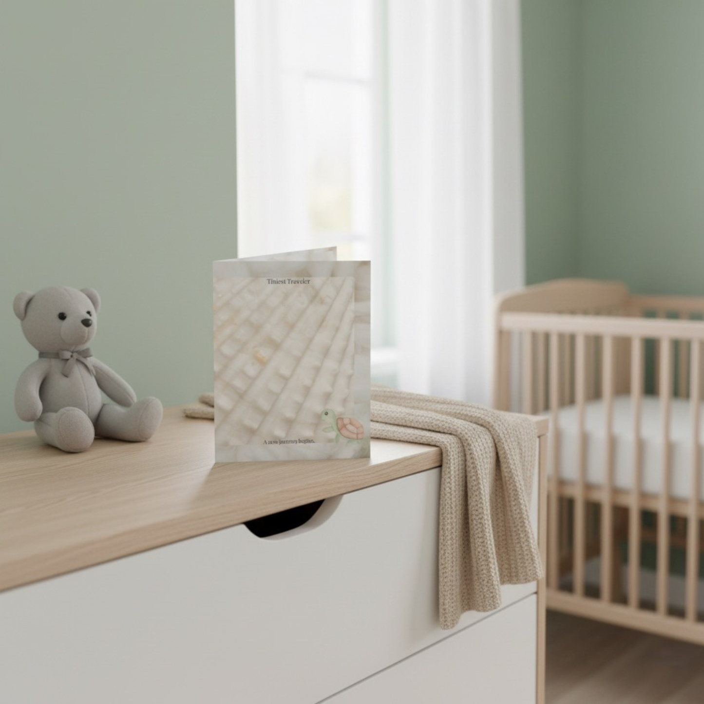 Tiniest Traveler baby card displayed in sage green nursery with crib - minimal baby shower card for new parents