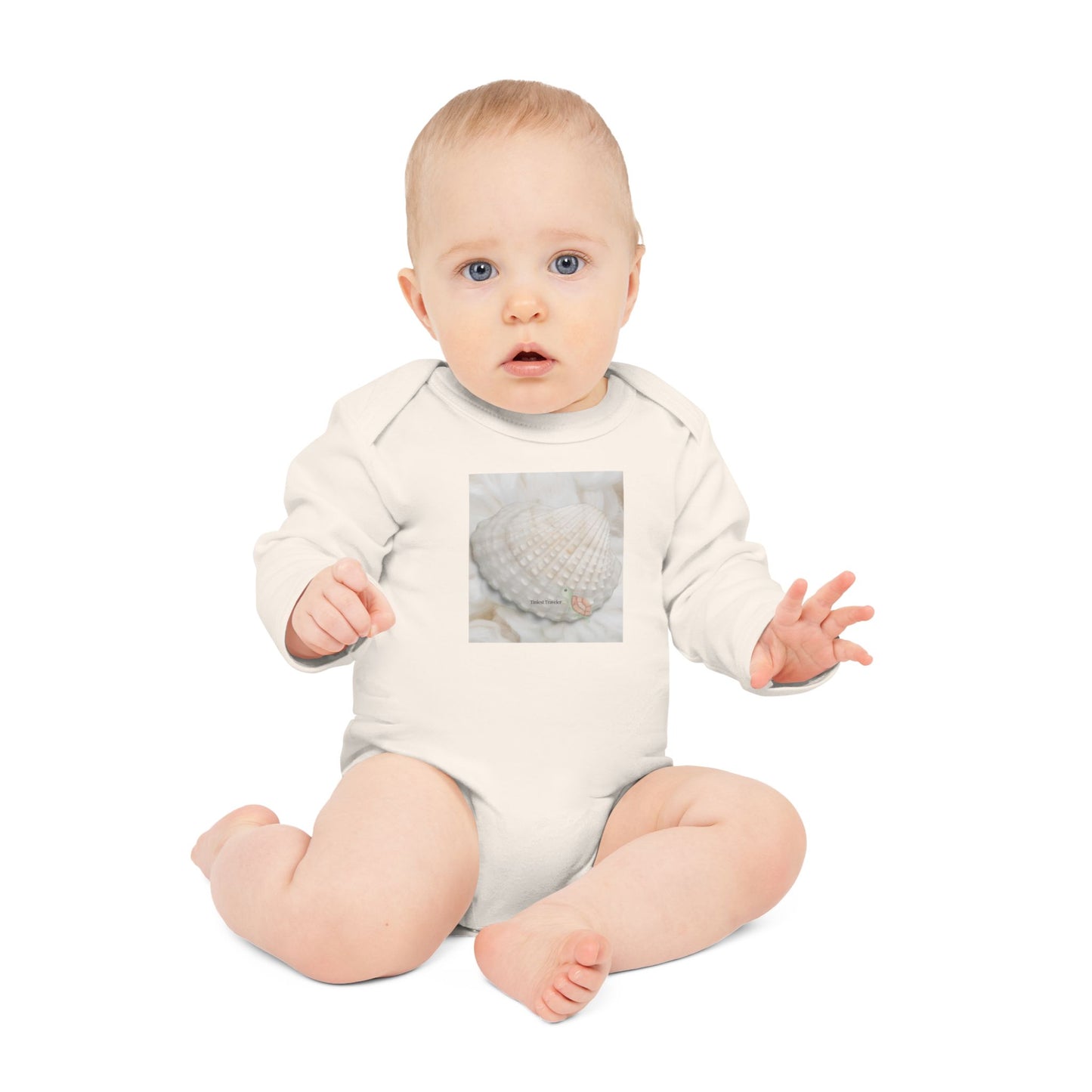 Baby wearing the Tiniest Traveler bodysuit in organic natural cotton, soft-toned and serene.