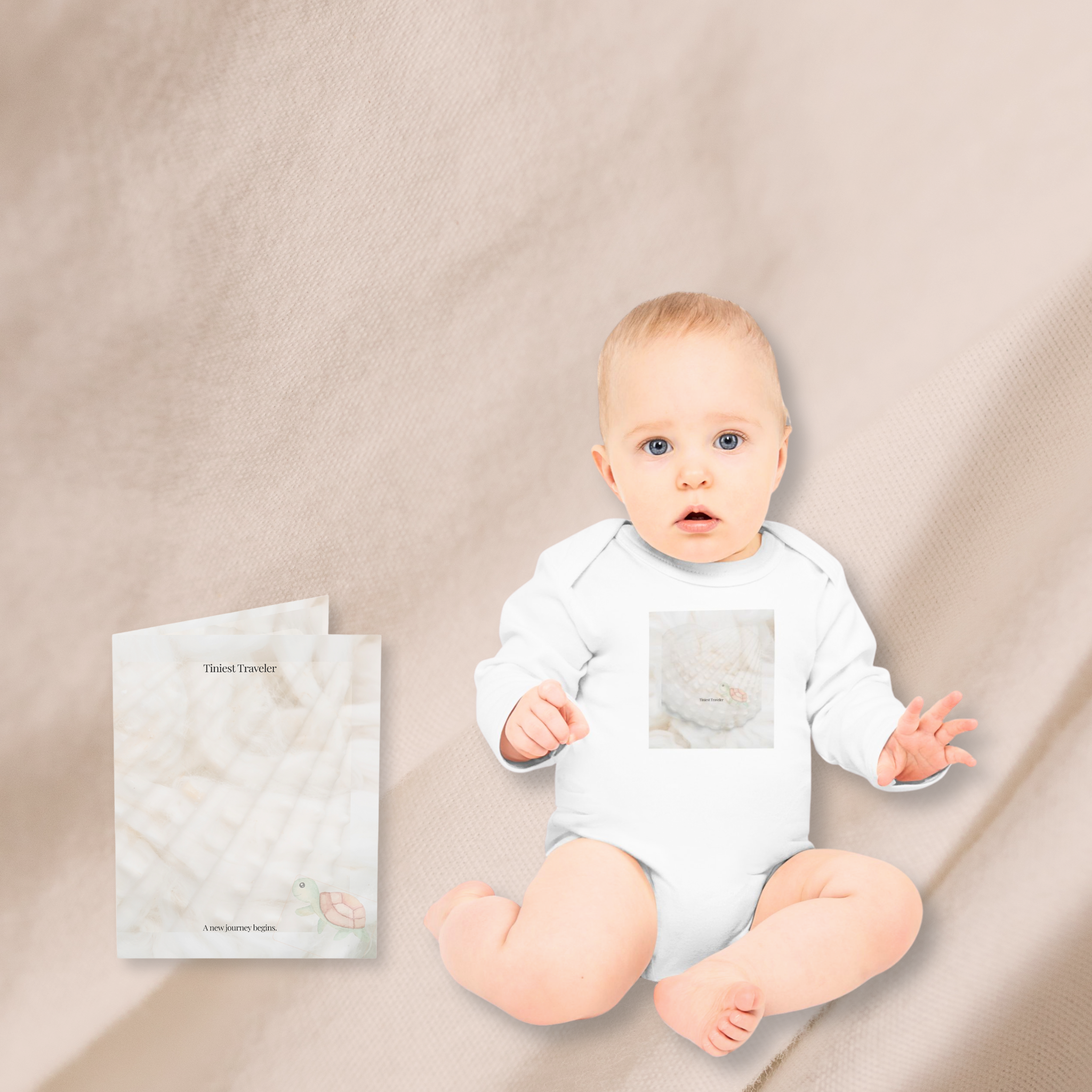 a baby wearing the Tiniest Traveler long-sleeve organic cotton bodysuit sits on a soft beige background next to the matching art card that reads "A new journey begins"