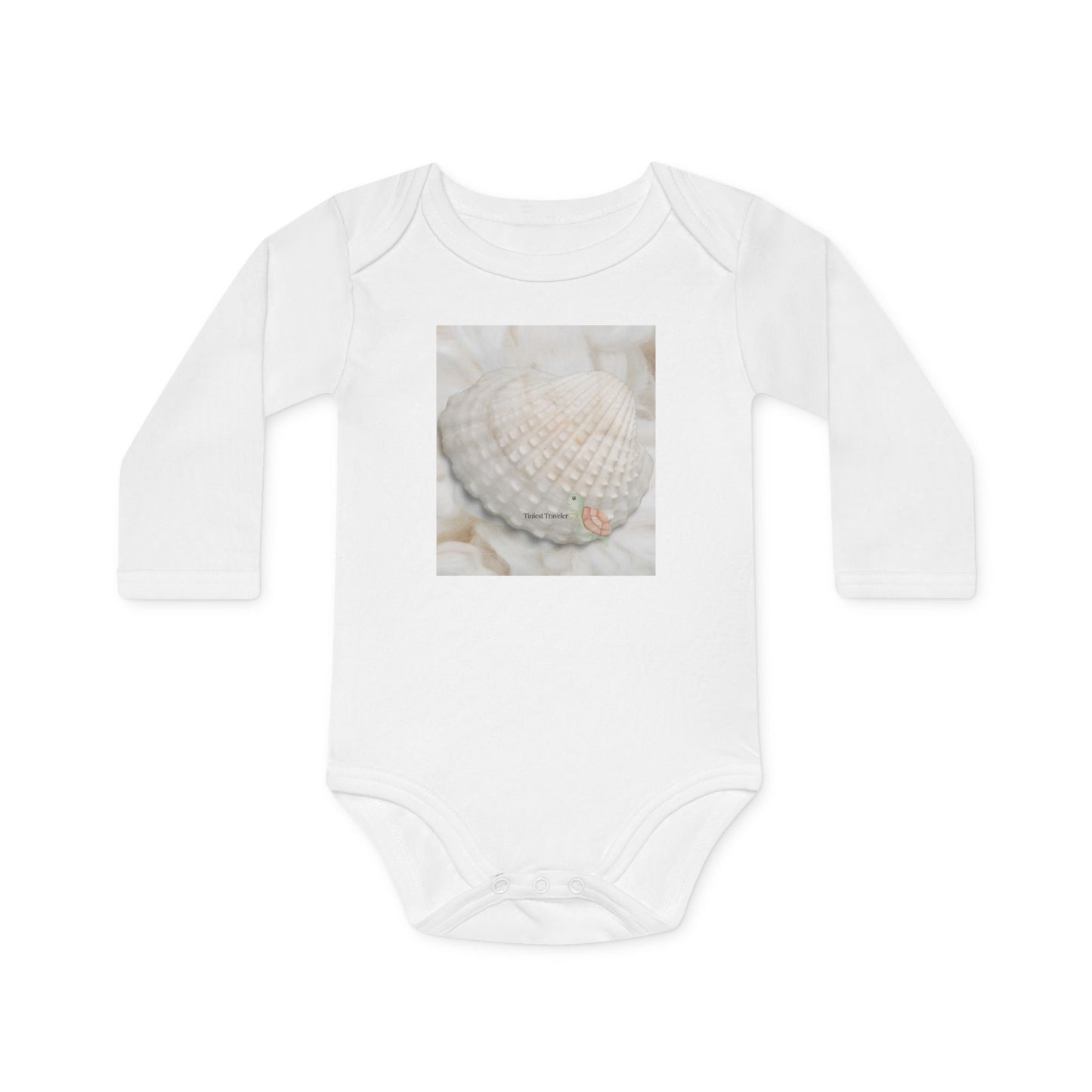 front view of the tiniest traveler organic cotton long sleeve bodysuit. featuring a cotton ackground and a shell, with a little turtle illustration, it's writtin "Tiny Traveler"
